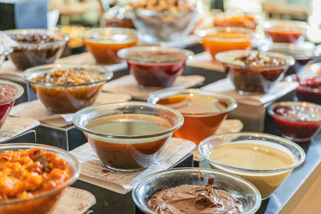 Enjoy Dead Sea Hotel Эйн-Бокек Экстерьер фото A selection of various sauces